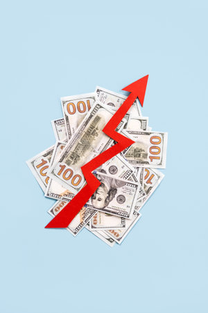 Global economy recovery, Business Economic growth. Financial, industrial and market sector comeback and upturn concept. Paper red arrow graph on 100 dollar bills going upward in blue backgroundの写真素材