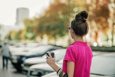 Cities and Mental Health. Living in big, cities, increased population density, traffic noise, metropolis pollution. Brunette young woman on the street of big city, megalopolisの写真素材