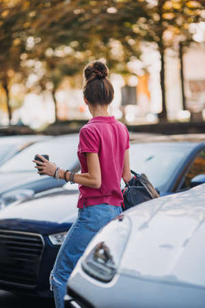 Cities and Mental Health. Living in big, cities, increased population density, traffic noise, metropolis pollution. Brunette young woman on the street of big city, megalopolisの写真素材