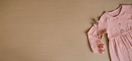 Muslin Eco Friendly Clothing, Organic Muslin Clothes. Natural tones dresses on beige recycled cardboard backgroundの写真素材