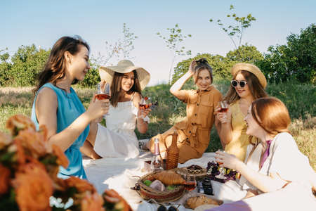 Young women girl friends at picnic.の写真素材