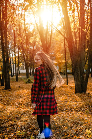 Vitamin D in autumn and winter season. Vitamin D in Womens Health, Role of Vitamin D3 Supplements in female health. Young woman enjoying sun in fall nature backgroundの写真素材