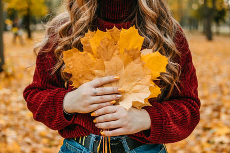 Faceless portrait of woman with maple leaves. Activities for Happy Fall, Improve Yourself, Ways To Be Happy And Healthy autumn. Embrace Life, Mindfulness, Wellness, Empowerment, Mindset in Fallの写真素材