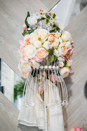 Floral Design Dress, floral fashion, flower dress. Flower arrangement delicate delicate pastel peonies and roses in the form of female figures on a frame. Flower shop decorationの写真素材