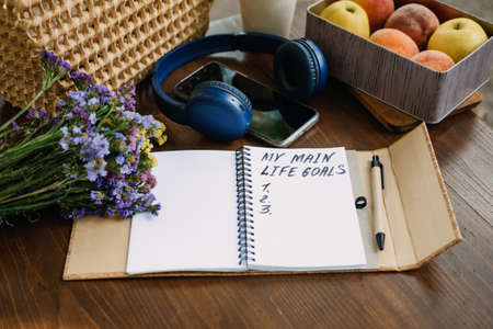 New Years Resolutions Life Goals list in open notebook on the table. Outdoor still life with My Life Goals motivational text. Self-development and motivationの写真素材