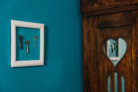 Key in frame on blue wall backgroung. Key new home, homeownership, keys to the house, buying homeの写真素材