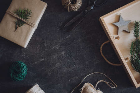 Zero waste, Sustainable, green, eco-friendly Christmas gifts. Zero Waste Gift Wrapping flat lay. Craft paper gift box, twine and scissors on wooden tableの写真素材