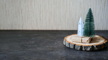 Christmas Banner, Xmas minimal background with craft gift boxes and cone toy Christmas tree on wooden dark background. Zero waste, Sustainable, green, eco-friendly Christmas Bannerの写真素材