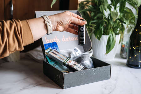 Bath detox beauty box with black charcoal cosmetic and beauty devices. Beauty box with Konjac Sponge, Cleansing Oil, Beauty Mask, Soap Bar, Bamboo Toothbrush. Kropivnitskiy, Ukraine, March 20, 2021のeditorial素材