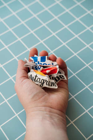 Social media addiction, detox, fomo. Crumpled Paper logos of social networks and online messengers Facebook, Instagram, YouTube, Telegram and others in hand. Kropivnitskiy, Ukraine, October 04, 2021のeditorial素材