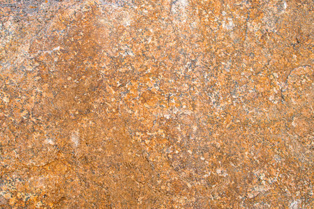 Raw rough yellow golden brown granite texture background. Natural rock stone texture background. Granite Grades. Muscovite colored minerals in graniteの写真素材