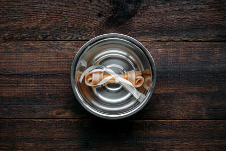 Dog bone in bowl on wooden background. Artificial bones for pets. Long Lasting Dog Chew Boneの写真素材