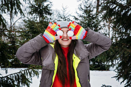 Outdoor activities for happy winter holidays. Winter Bucket List, Fun Activities and Things for adults When its Cold outside. Happy girl playing with snow and enjoying life in winter park, forestの写真素材