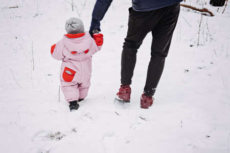 Fathers of Daughters, Raising Girls. Dads Having a Baby Girl. Happy father playing with little baby toddler girl daughter in winter park, forest. Happy family on winter weekend, Christmas holidaysの写真素材