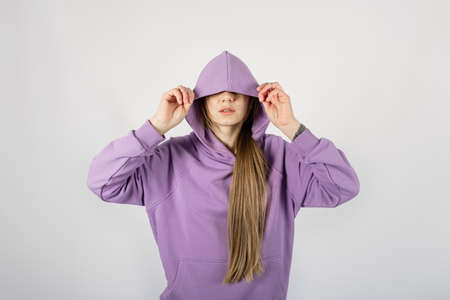Full length portrait of young sporty fitness women in blue cotton hooded sweatsuit casual outfit. studio shot of blonde Hoody woman with long hair in long sleeve tracksuits hoodie activewear set.の写真素材