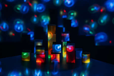 Metaverse, future, digital technology concept. Wooden constructor blocks on abstract multicolored neon lights background.の写真素材