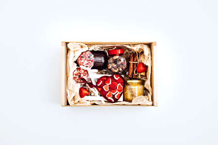Valentine Day gift box with sweets, candy, vegetarian healthy organic food . Valentines Day flat lay with gift box with yummy heart shape sweets on white backgroundの写真素材