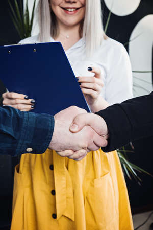 Businessmen People in informal casual clothes shaking hands. Client or customer and business owner agreement, business partner, Cooperation concept.の写真素材