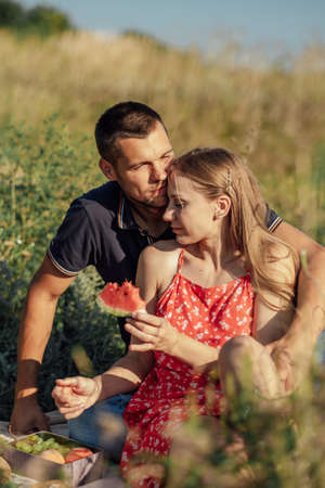 Romantic Picnic Date Ideas. Young couple in love on summer picnic with watermelon.の写真素材
