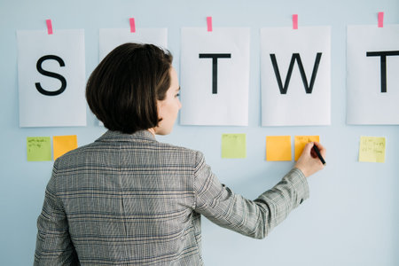 Business planning strategy. Businesswoman, manager standing in office in front of the chart white...