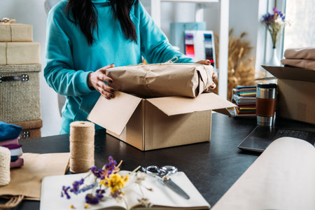 Small business owner, woman hold package box, receiving purchase order, working at office.