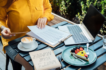 Modern astrologer numerologist woman working and writing in notepad numbers. Numerology, astrology