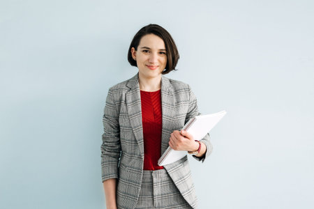 Portrait of young confident businesswoman in modern office. Woman-Owned Business,