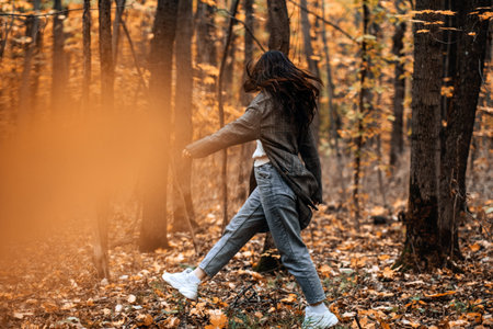 Autumn Anxiety, Mental Health. Happy brunette woman enjoy life in autumn forestの写真素材