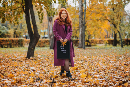 Hello autumn. Red hair girl with Letter message board with text Autumn is my favorite color