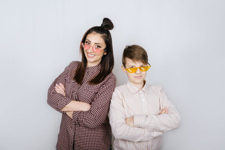 Studio Portrait of happy family mom and teenager son boy in colored glasses having fun