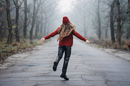 Weekend breaks and getaways in forests. Stay close to nature. Young woman in red hat and sweater