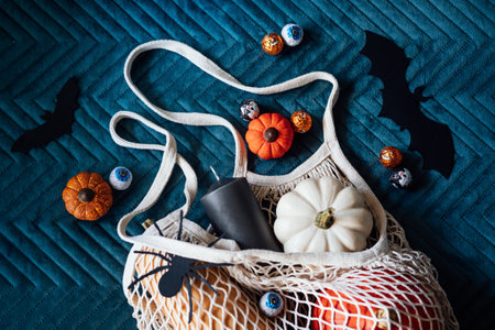 Sustainable Halloween. Eco-Friendly Halloween, plastic free trick-or-treating, Green Halloween. Zero waste Halloween decoration pumpkins, paper bats and spiders, candy in zero waste reusable bagの写真素材