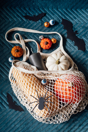 Sustainable Halloween. Eco-Friendly Halloween, plastic free trick-or-treating, Green Halloween. Zero waste Halloween decoration pumpkins, paper bats and spiders, candy in zero waste reusable bagの写真素材