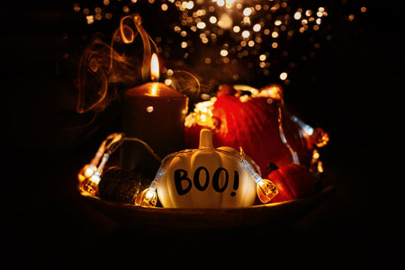 Halloween composition pumpkins and lights glow in the dark among the smoke fog. Halloween pumpkin with word Boo on black background in smoke.の写真素材