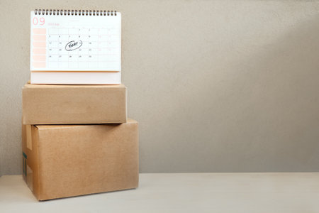 Same Day delivery Ship From Store. Faster Delivery. Many Cardboard boxes and calendar with the date today ready for deliveryの写真素材