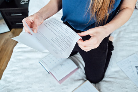 Happy excited woman student customer reading offer letter with good news, great cheap offer, get job opportunity. Young woman holding paper mail bank statement letter at homeの写真素材