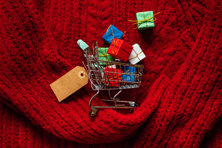 Christmas xmas shopping banner with mockup label. Shopping cart with many gift boxes with cardboard...