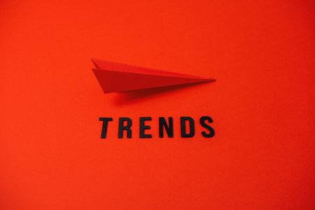 Global World Trends, Top New trends, forecasting. Word trends and red paper plane on red background.