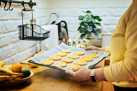How to Dry Orange Slices for Holiday Decor. Process of Drying Orange Slices in the Oven. Woman...