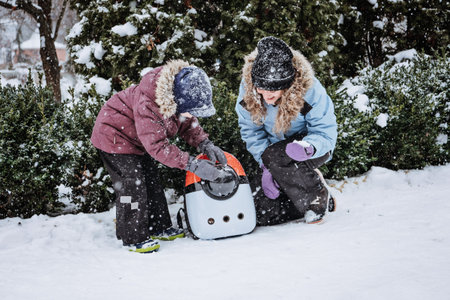 Outdoor Cat Care in Winter. Cold Weather Cat Safety. Cats in Winter. Family mother and Little boy...