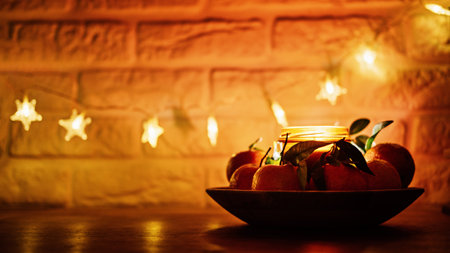 Christmas candles night evening dark background web banner. Citrus candle for festive season and juicy oranges on kitchen wooden table. New Home Christmas Candle Personalised Candle Jar.の写真素材