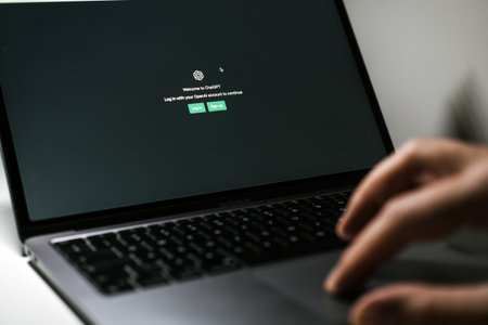 Screen with ChatGPT chat with AI or artificial intelligence. Man search for information using...