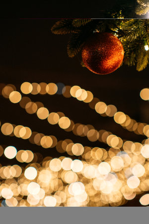 Christmas Outdoor lighting, Urban lighting, Festive lights. Christmas city street illumination blurred lights in eveningの写真素材