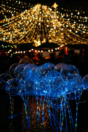 Christmas Outdoor lighting, Urban lighting, Festive lights. Christmas city street illumination blurred lights in eveningの写真素材