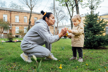 Grandparents in kids life, Grandparents teach children. Senior woman grandmother and little toddler girl playing outdoor. Playful activities with grandparents.の写真素材