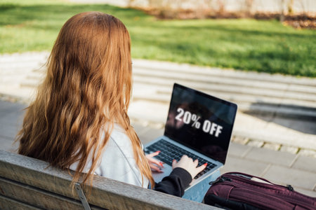 Student Discounts and student deals. Student discount is offer on product or service exclusively for students studying at school, college or university. Student hands with discount signの写真素材