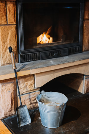 How to Remove Wood Ashes In Fireplace, How To Properly Clean Ashes Out Of Home Fireplace. Cleaning fireplace with open tray. Fireplace, wicker basket for firewood, pile of logs for a fireの写真素材