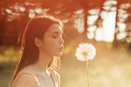 Pollen season. Summer allergies are caused by pollen from grass and Flowers. Young woman smells the blooming Flowers. Pollen and molds Causes Summer Allergiesの写真素材