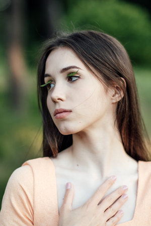 Mindfulness Practices to Connect with Nature, relaxation breathing techniques. Outdoor portrait of calm young woman in nature backgroundの写真素材