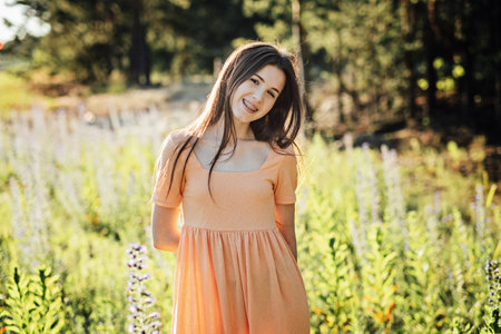Enjoy a healthy, fun and happy summer. Outdoor portrait of happy smiling young woman in nature background.の写真素材